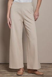 Model Madelinec wearing size 10 of the The Wide Leg Ponte Pant - Sand in colour Sand, in a cropped view