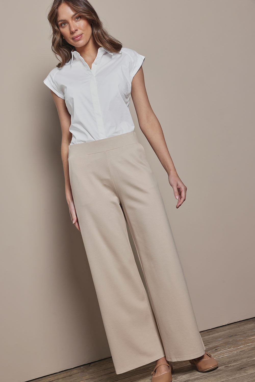Model Madelinec wearing size 10 of the The Wide Leg Ponte Pant - Sand in colour Sand, from the front