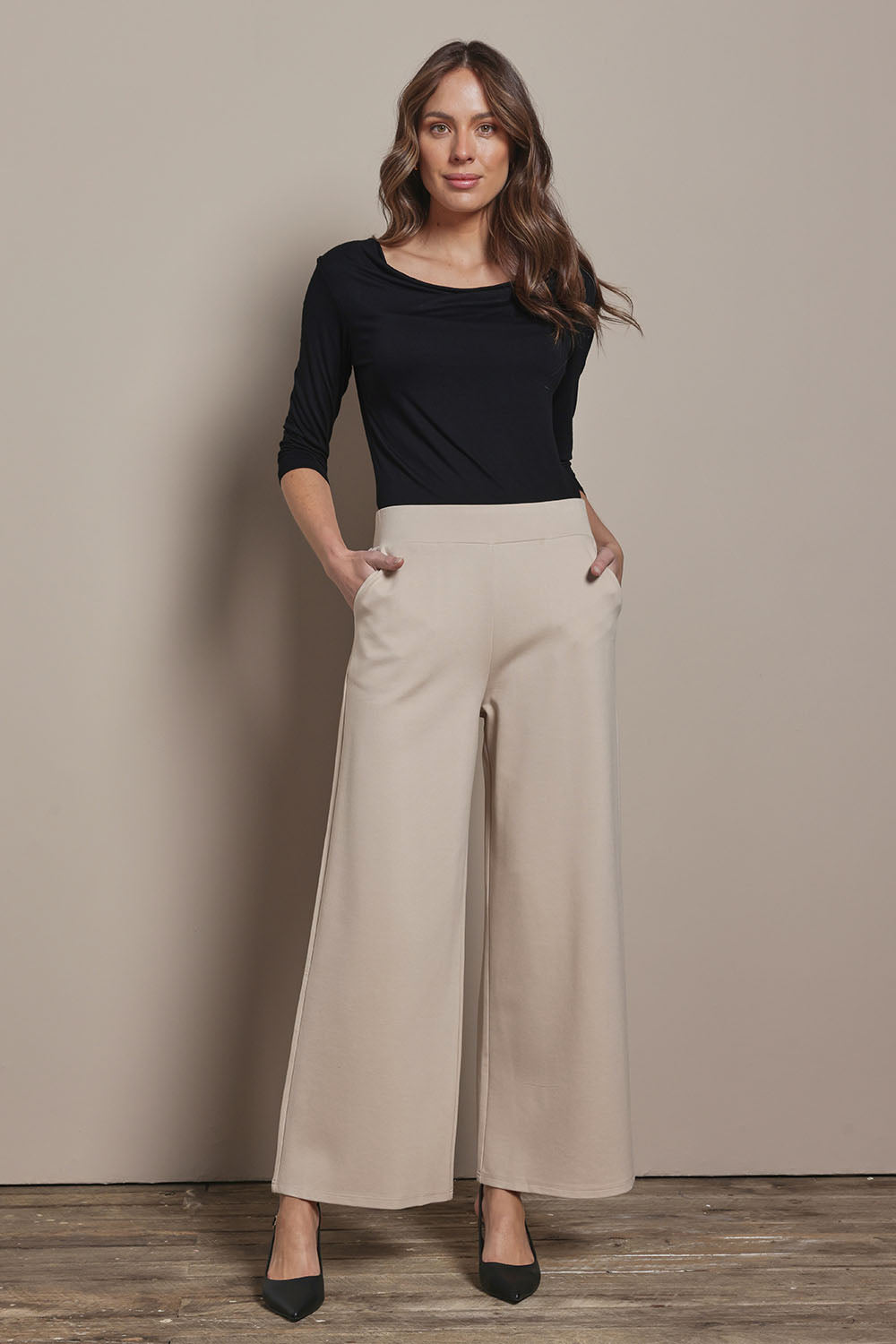 Model Madelinec wearing size 10 of the The Wide Leg Ponte Pant - Sand in colour Sand, from the front