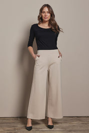 Model Madelinec wearing size 10 of the The Wide Leg Ponte Pant - Sand in colour Sand, from the front