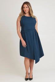 Model Chanel wearing size 16 of The Side Pleated Dress in colour Deepocean (Blue), from the front, showing the whole outfit