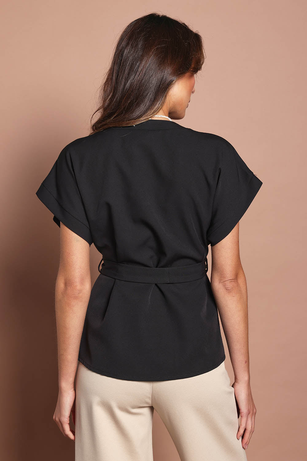 Model Madeline wearing size 10 of The Kimono Top in colour Black (Black), from the back