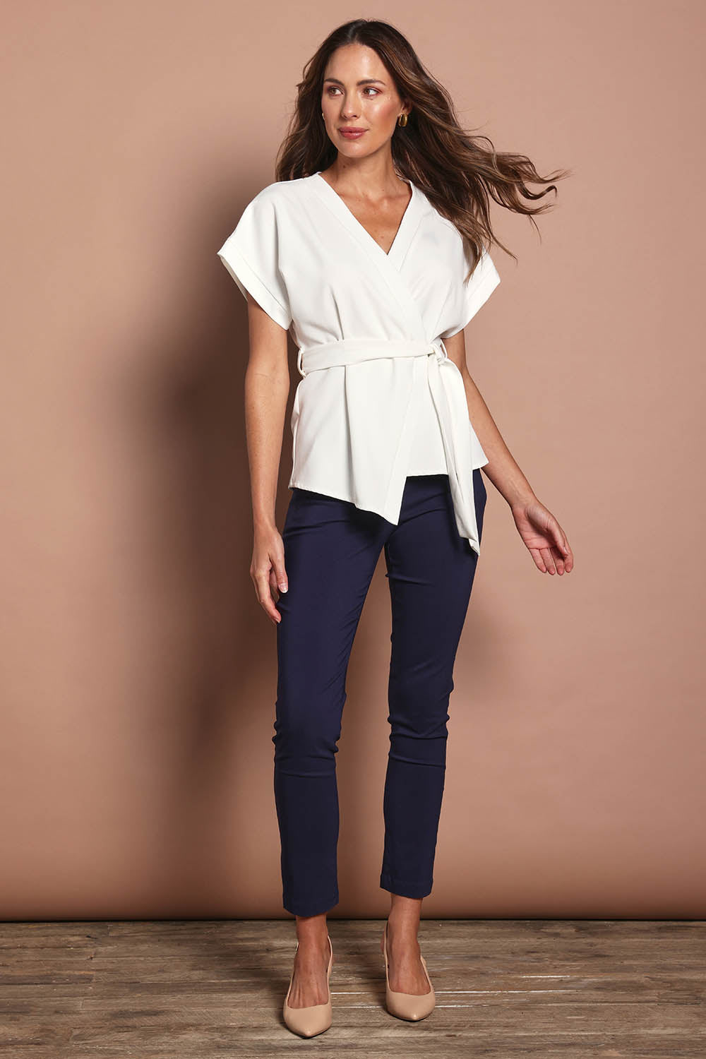 Model Madeline wearing size 10 of The Kimono Top in colour Ivory (White), from the front, showing the whole outfit