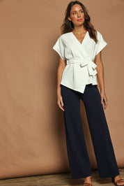 Model Madeline wearing size 10 of The Kimono Top in colour Ivory (White), from the front, showing the whole outfit