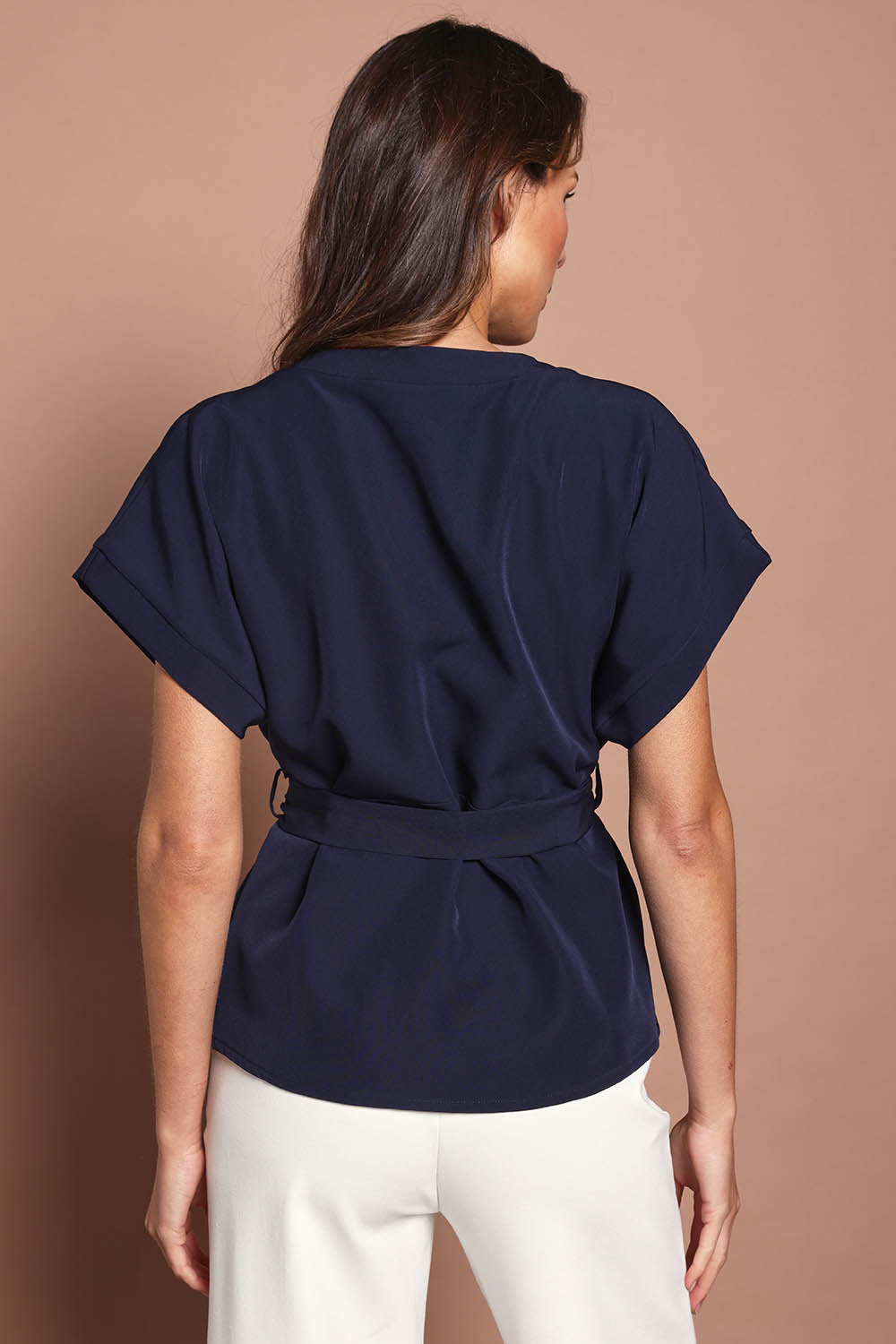 Model Madeline wearing size 10 of The Kimono Top in colour Navy (Blue), from the back