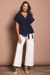 Model Madeline wearing size 10 of The Kimono Top in colour Navy (Blue), from the front, showing the whole outfit