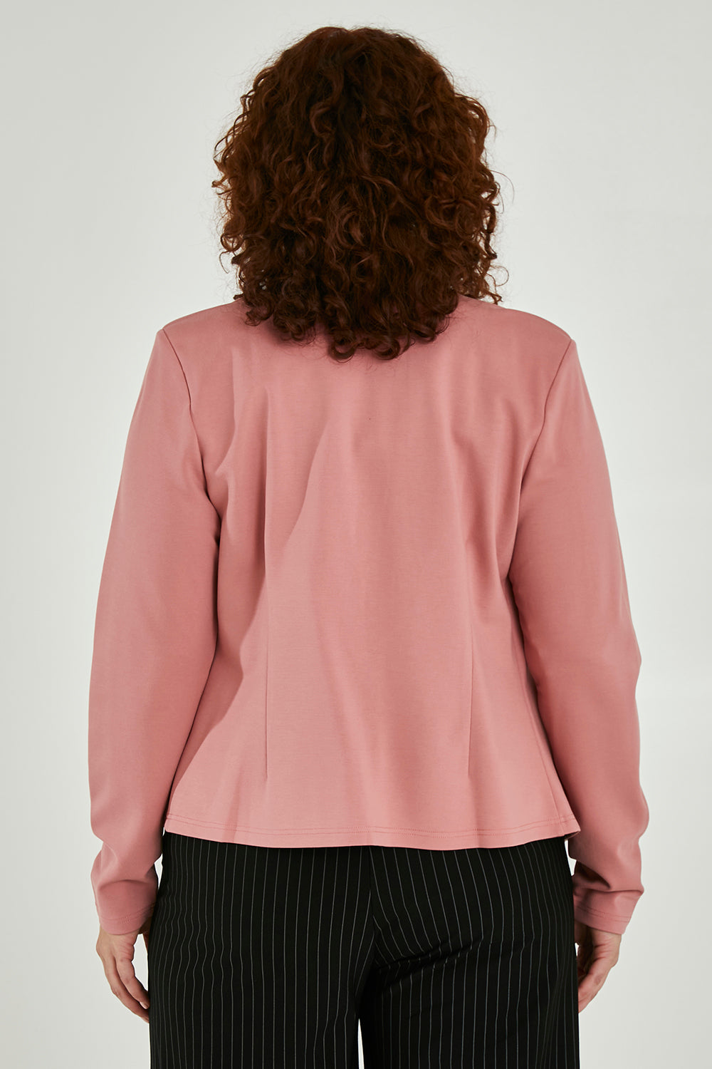 Model Maddy wearing size 16 of The Define Ponte Jacket in colour Rose (Pink), from the back