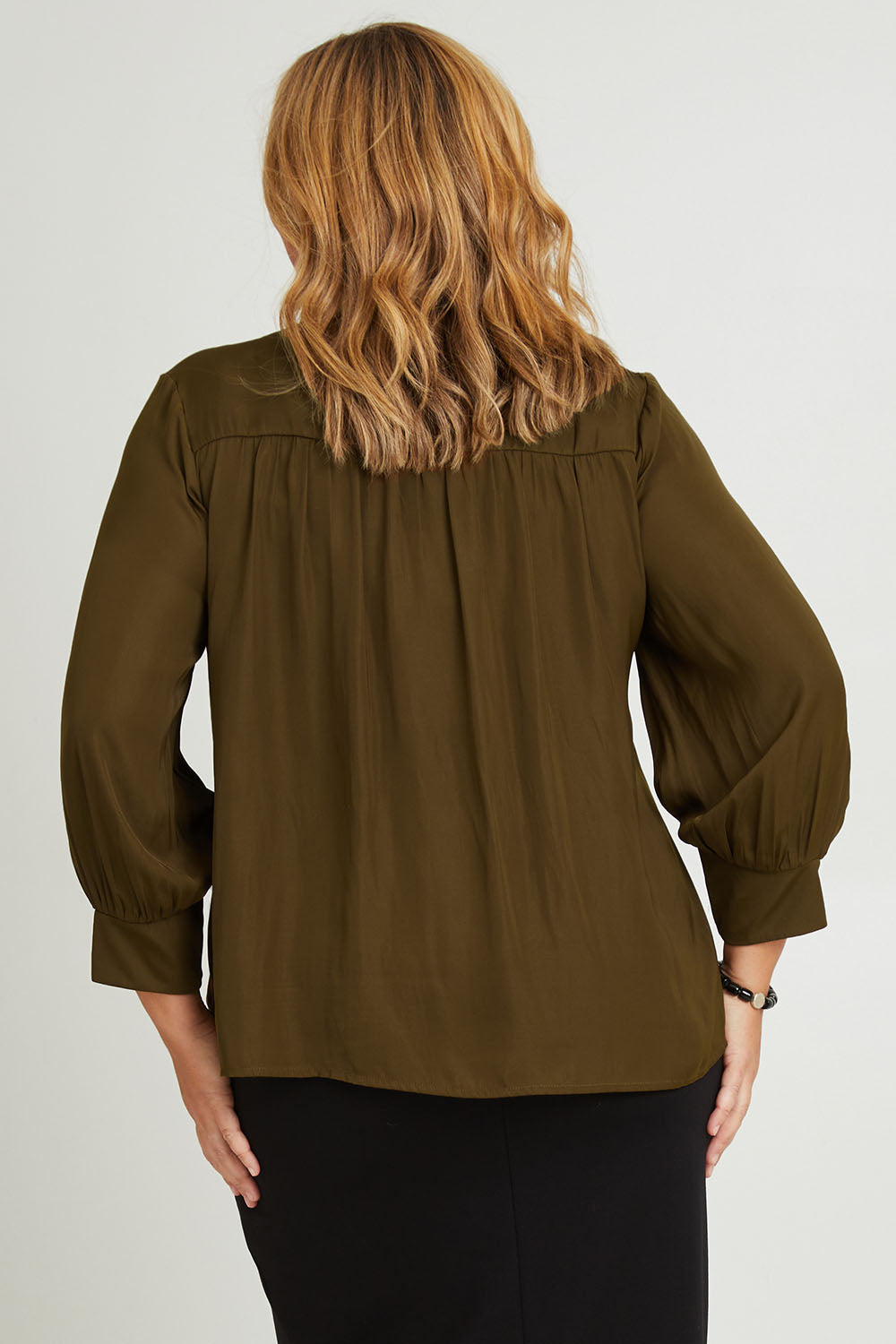 Model Fiona wearing size 16 of The Luxe V Neck Blouse in colour Sepia, from the back