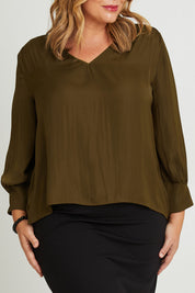 Model Fiona wearing size 16 of The Luxe V Neck Blouse in colour Sepia, from the front, cropped image