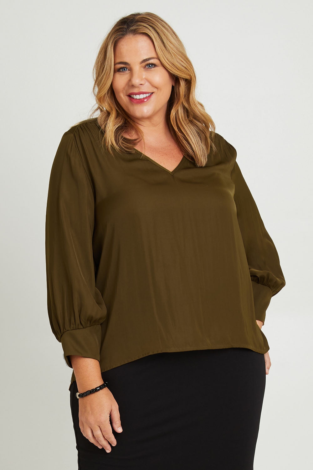 Model Fiona wearing size 16 of The Luxe V Neck Blouse in colour Sepia, from the front, cropped image