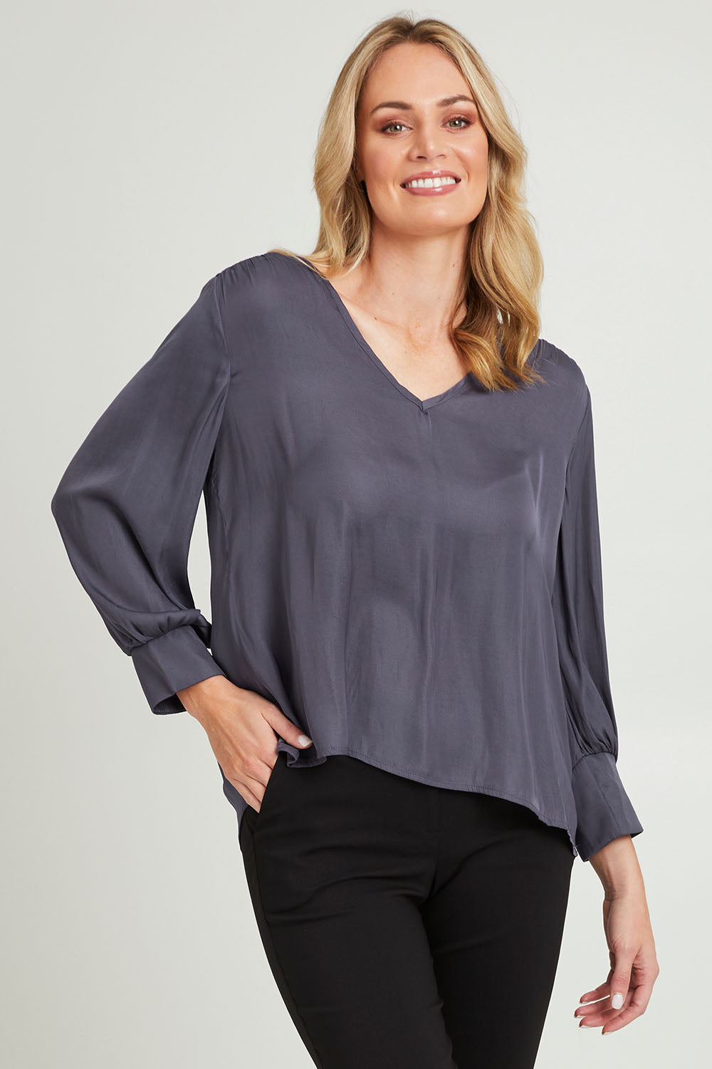 Model Grace wearing size 10 of The Luxe V Neck Blouse in colour Slate (Grey), from the front, cropped image