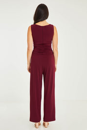 Model Stacey wearing size 10 of The Cross Waist Jumpsuit in colour Port (Purple), from the back