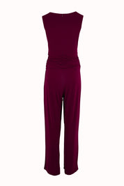Product shot of The Cross Waist Jumpsuit in colour Port (Purple), from the back