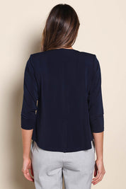 Model Madelinec wearing size 10 of the The Modern Shrug – Navy in colour Navy, from the back
