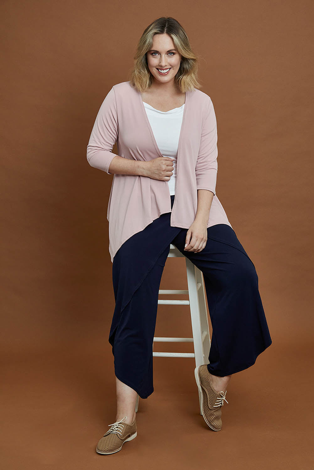 Model Jess wearing size 14 of The Drape Cardi in colour Blushpink (Pink), from the front, showing the whole outfit