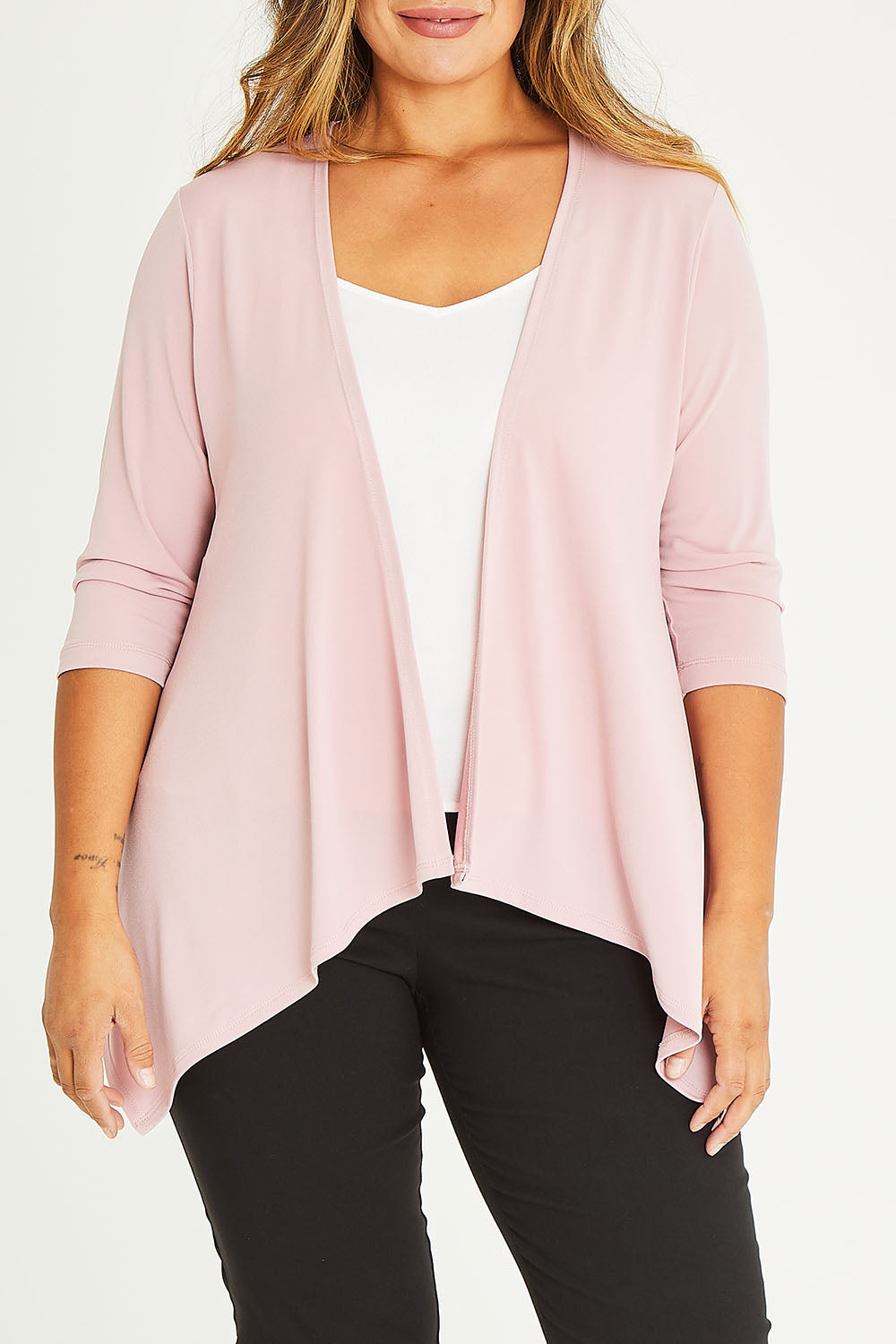Model Palatina wearing size 16 of The Drape Cardi in colour Blushpink (Pink), from the front, cropped image