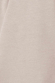 Product shot of The Asymmetrical Hem Coat in colour String, detail