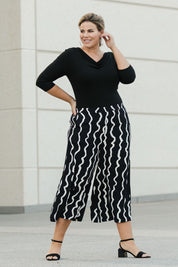 Model Fiona wearing size 16 of The Luxe Printed Pull On Culottes in colour Squiggle (Black), from the front, showing the whole outfit