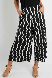 Model Pamela wearing size 10 of The Luxe Printed Pull On Culottes in colour Squiggle (Black), from the front, cropped image