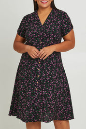 Model Ashleigh wearing size 16 of The Printed Cotton V Neck Dress in colour Ditsy (Black), from the front, cropped image