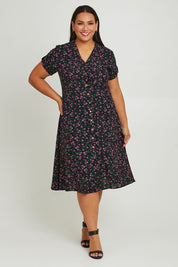 Model Ashleigh wearing size 16 of The Printed Cotton V Neck Dress in colour Ditsy (Black), from the front, showing the whole outfit