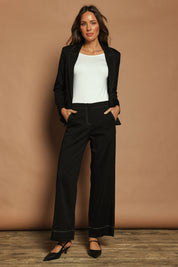 Model Madeline wearing size 10 of The Contrast Stitching Stretch Pant in colour Black (Black), from the front, showing the whole outfit