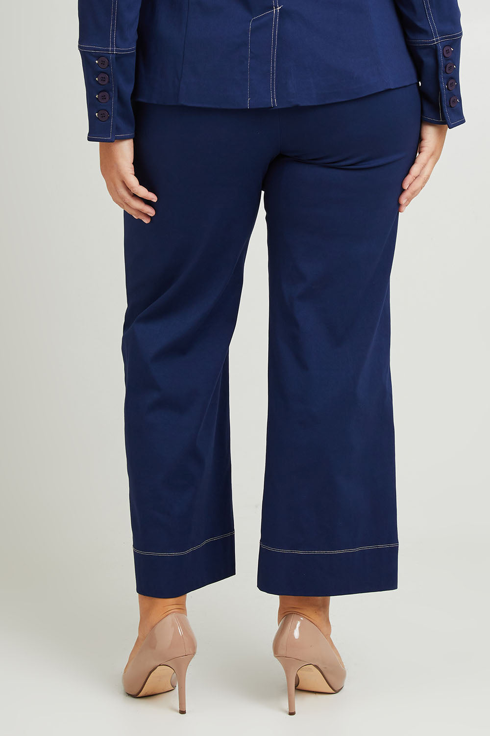 Model Fiona wearing size 16 of The Contrast Stitching Stretch Pant in colour Navy (Blue), from the back