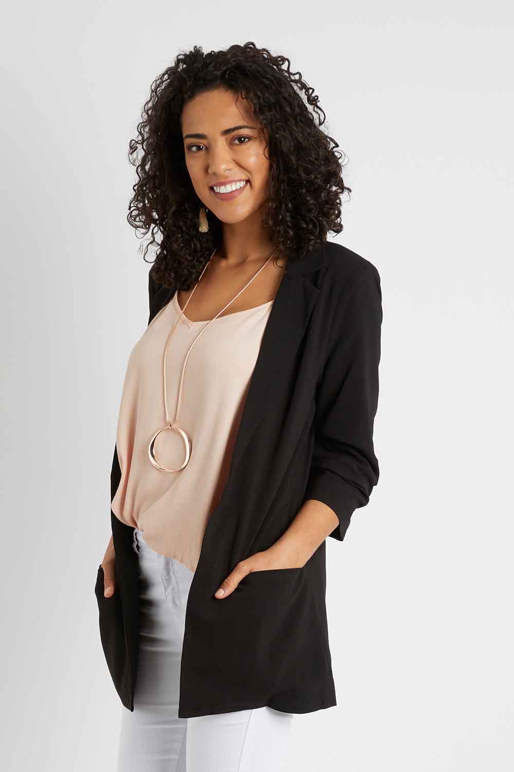 Model Pamela wearing size 10 of The Soft Fall Ruched Sleeve Blazer in colour Black (Black), from the front, cropped image