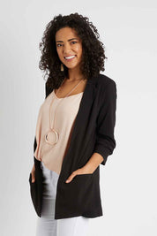 Model Pamela wearing size 10 of The Soft Fall Ruched Sleeve Blazer in colour Black (Black), from the front, cropped image