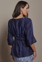 Model Madeline wearing size 10 of The Luxe Dolman Sleeve Blouse in colour Darkcobalt (Blue), from the back