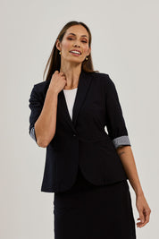 Model Amanda wearing size 10 of The Contrast Inner Cuff Blazer in colour Ink (Blue), from the front, showing the whole outfit