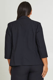 Model Ashleigh wearing size 16 of The Contrast Inner Cuff Blazer in colour Ink (Blue), from the back