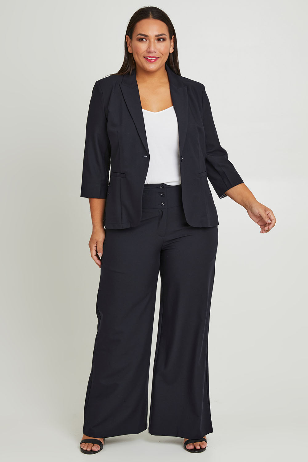 Model Ashleigh wearing size 16 of The Contrast Inner Cuff Blazer in colour Ink (Blue), from the front, showing the whole outfit