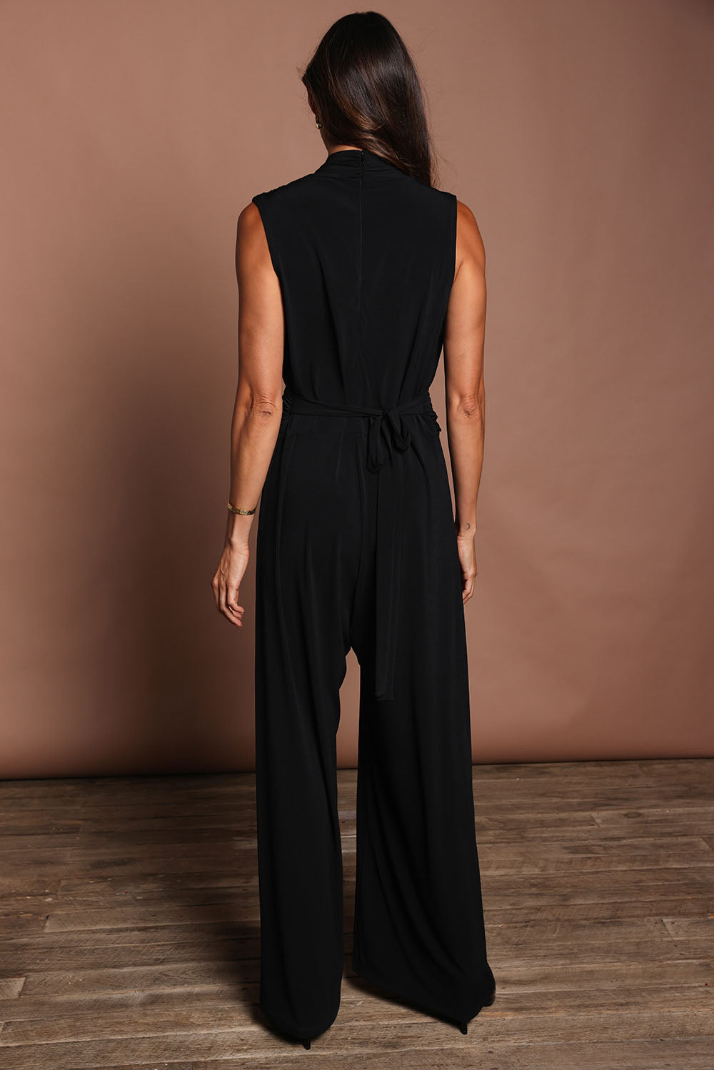 Model Amanda wearing size 10 of The Sleeveless Wide Leg Jumpsuit in colour Black (Black), from the back