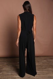 Model Amanda wearing size 10 of The Sleeveless Wide Leg Jumpsuit in colour Black (Black), from the back