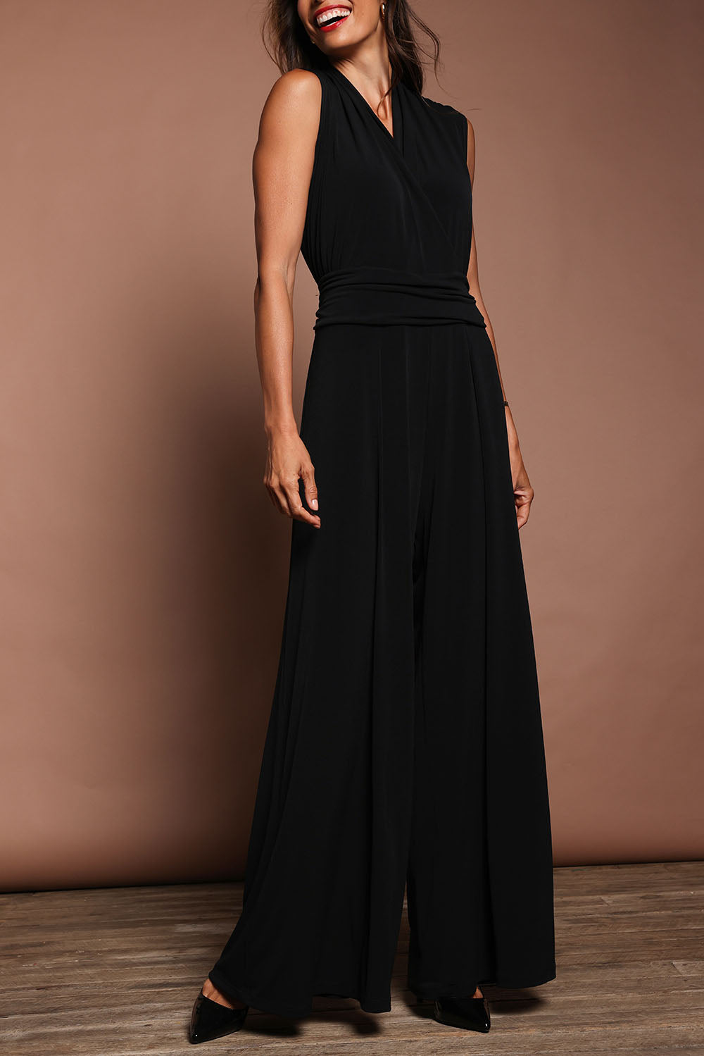 Model Amanda wearing size 10 of The Sleeveless Wide Leg Jumpsuit in colour Black (Black), from the front, cropped image