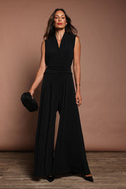 Model Amanda wearing size 10 of The Sleeveless Wide Leg Jumpsuit in colour Black (Black), from the front, showing the whole outfit