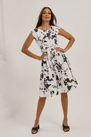 Model Amanda wearing size 10 of The Pleated Cotton Stretch Dress in colour Monofleur (White), from the front, showing the whole outfit