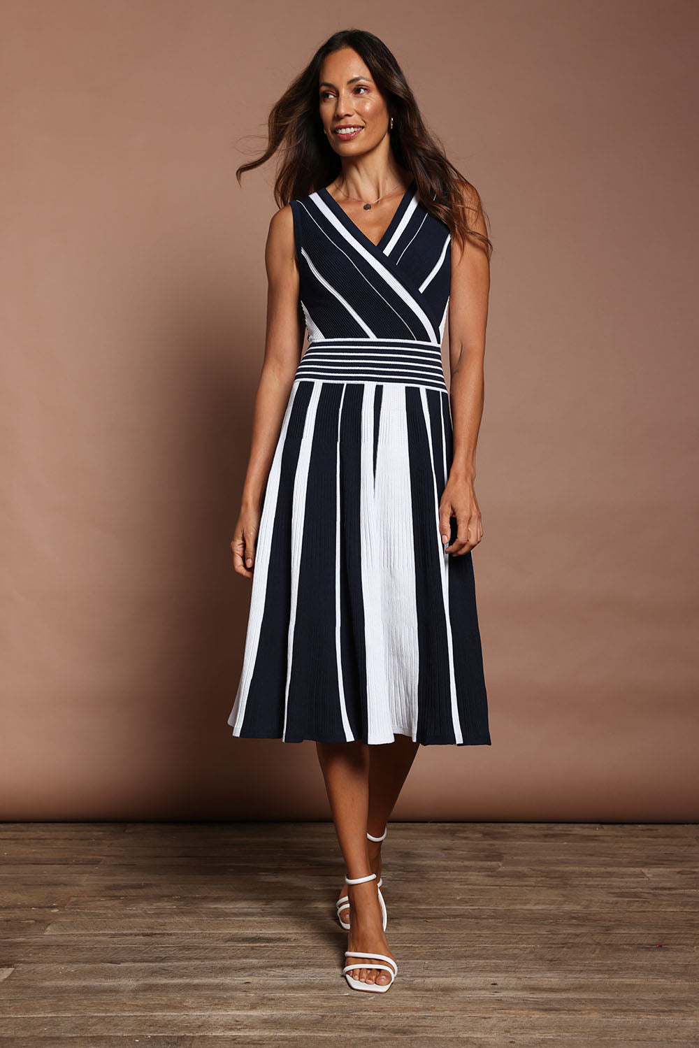 Model Amanda wearing size S of The Reversible Knit Dress in colour Navystripe (Blue), from the front, showing the whole outfit