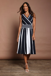 Model Amanda wearing size S of The Reversible Knit Dress in colour Navystripe (Blue), from the front, showing the whole outfit