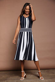 Model Amanda wearing size S of The Reversible Knit Dress in colour Navystripe (Blue), from the front, showing the whole outfit