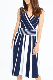 Model Cara wearing size S of The Reversible Knit Dress in colour Navystripe (Blue), from the front, cropped image