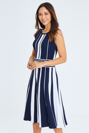 Model Cara wearing size S of The Reversible Knit Dress in colour Navystripe (Blue), from the front, cropped image
