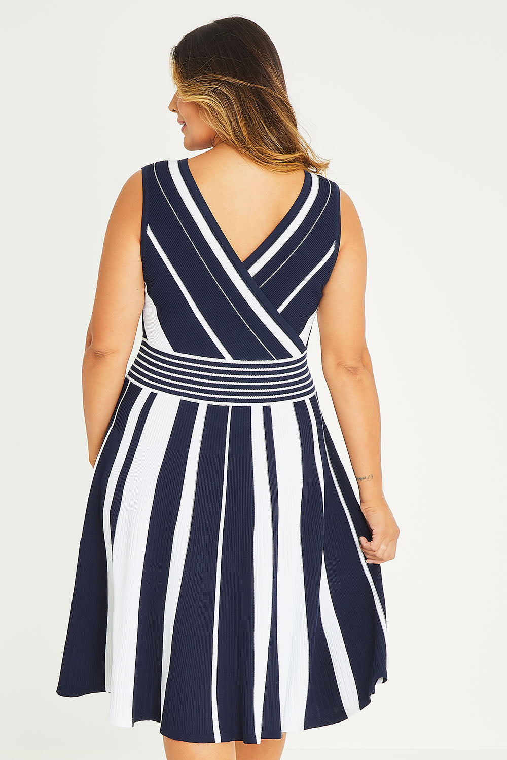 Model Palatina wearing size XL of The Reversible Knit Dress in colour Navystripe (Blue), from the back