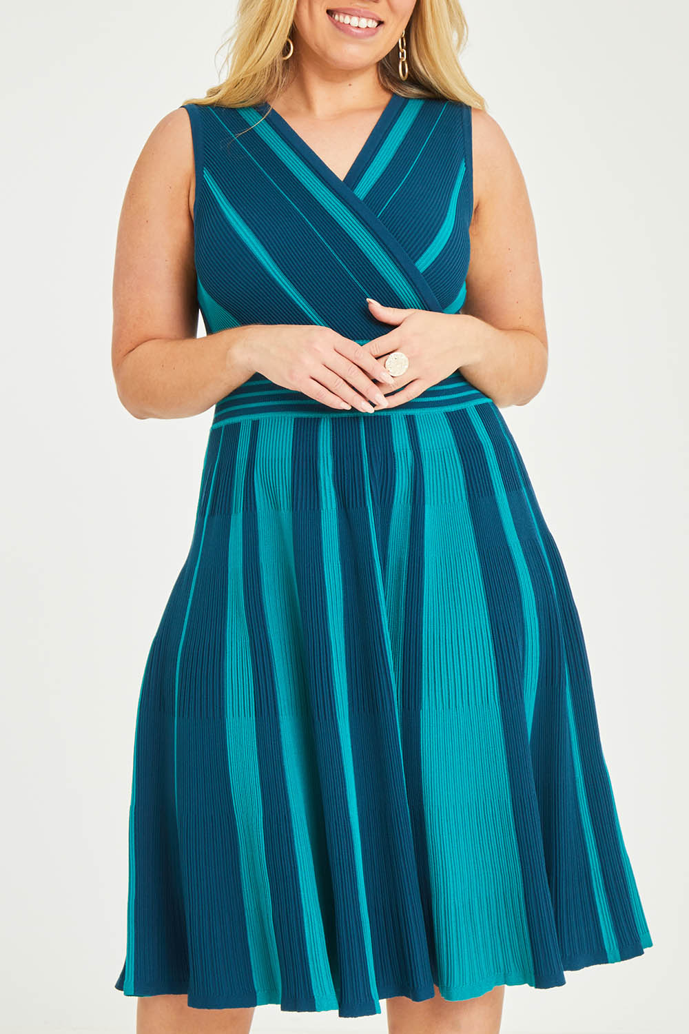 Model Katie wearing size XL of The Reversible Knit Dress in colour Peacock (Blue), from the front, cropped image