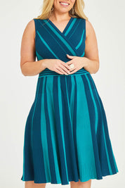Model Katie wearing size XL of The Reversible Knit Dress in colour Peacock (Blue), from the front, cropped image