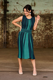 Model Miranda wearing size S of The Reversible Knit Dress in colour Peacock (Blue), from the front, showing the whole outfit