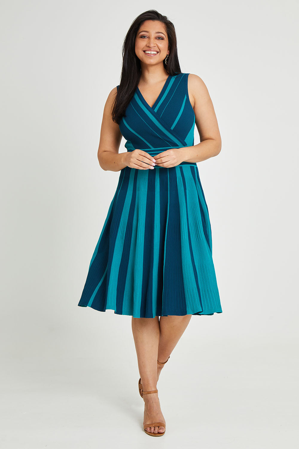 Model Terri-Leigh wearing size L of The Reversible Knit Dress in colour Peacock (Blue), from the front, showing the whole outfit