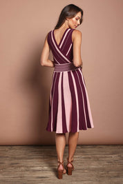 Model Madeline wearing size S of The Reversible Knit Dress in colour Plumstripe (Purple), from the back