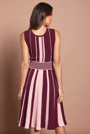Model Madeline wearing size S of The Reversible Knit Dress in colour Plumstripe (Purple), from the back